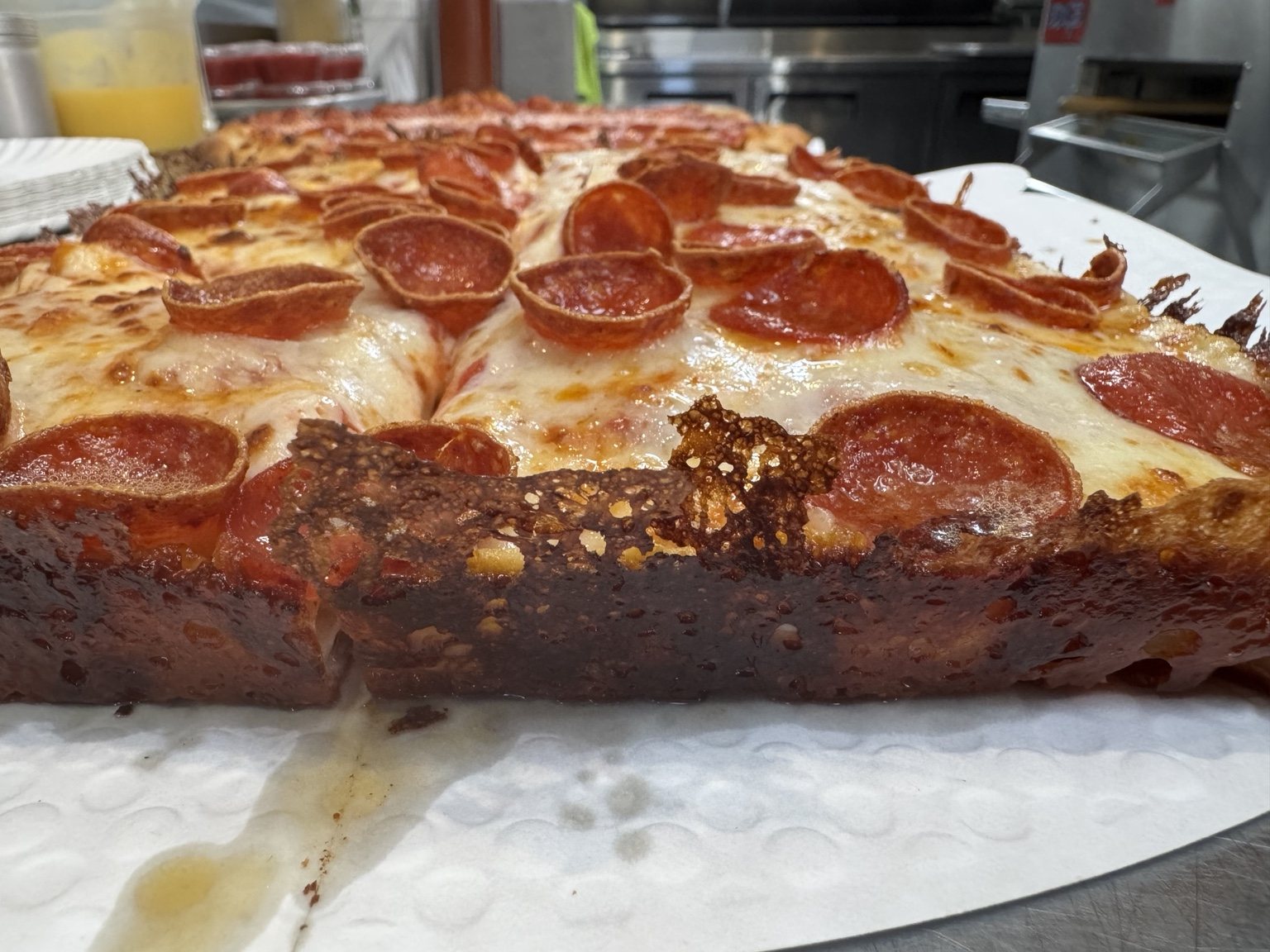 Detroit style pepperoni pizza with crispy cheese edge